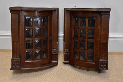 Lot 159 - A pair of carved oak hanging bowfront corner...