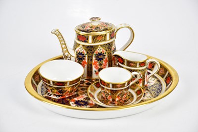 Lot 1353 - ROYAL CROWN DERBY; a miniature six piece tea...