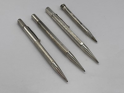 Lot 107 - Four sterling silver pencils.