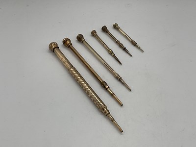 Lot 112 - Six gold plated propelling pencils.