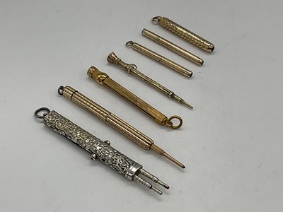 Lot 114 - Six gold plated small propelling pencils and...