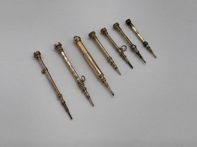 Lot 115 - Seven small gold plated propelling pencils,...