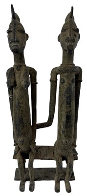 Lot 1078 - A Benin type bronze model of a seated couple,...