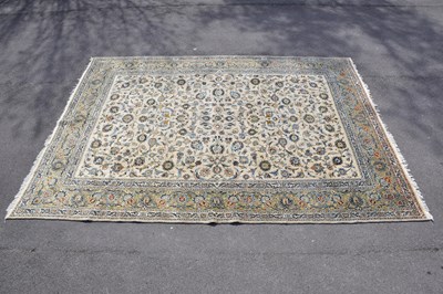 Lot 428 - A beige ground wool carpet with floral pattern,...