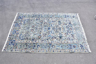 Lot 426 - A blue ground wool carpet with floral...