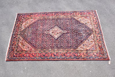 Lot 433 - An orange ground carpet with central geometric...