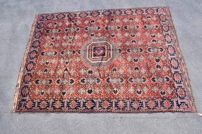 Lot 437 - An orange ground wool carpet with central...