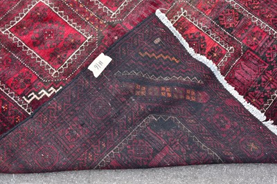 Lot 443 - A red ground wool carpet with geometric...