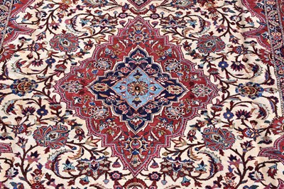 Lot 438 - A red ground silk machined carpet with floral...