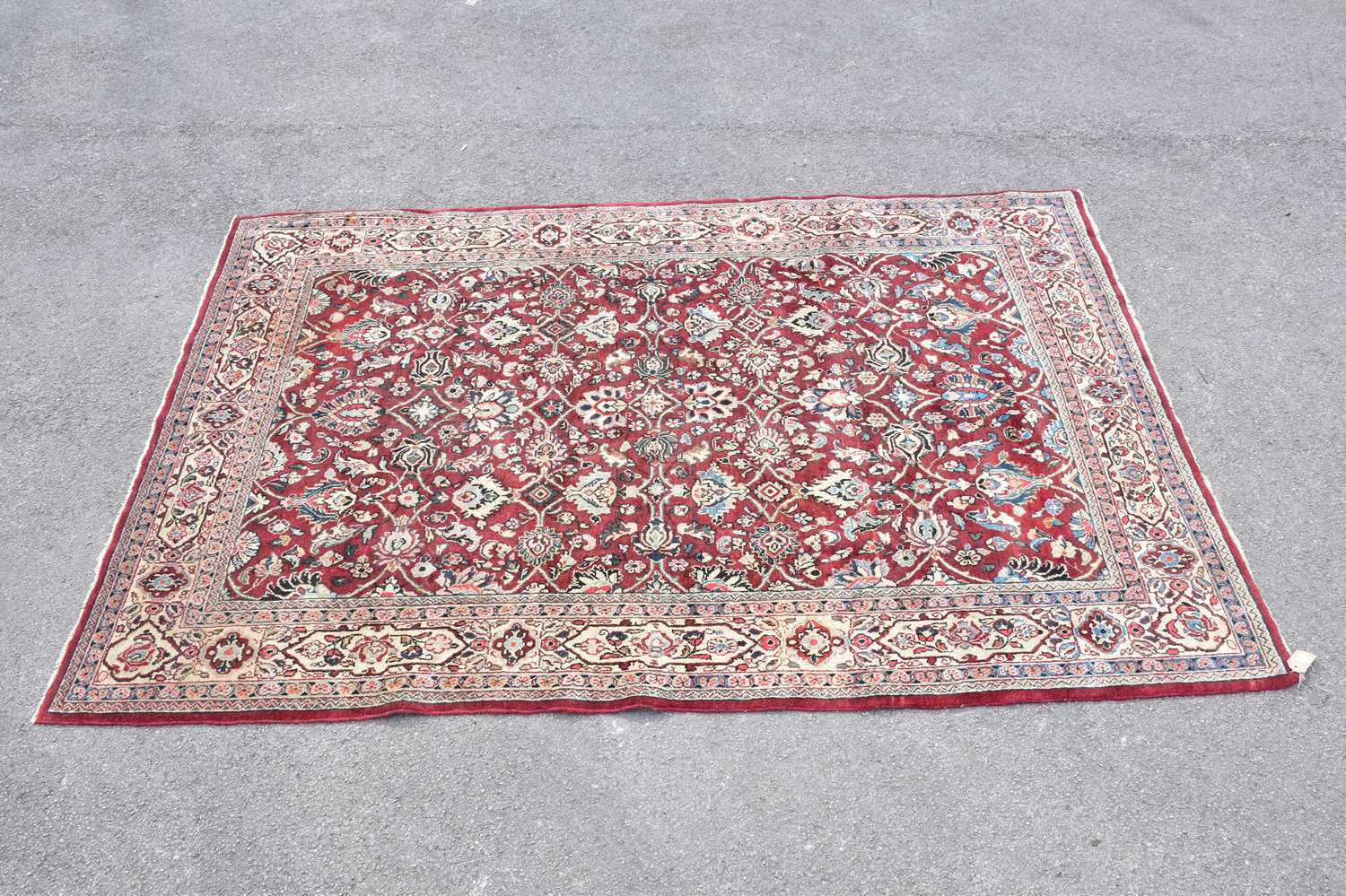 Lot 441 - A red ground wool carpet with floral geometric...