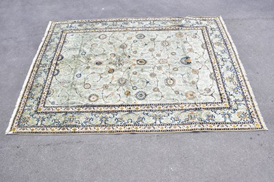 Lot 424 - A pale blue wool carpet with floral pattern,...