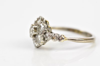 Lot 61 - An 18ct white gold diamond set floral dress...