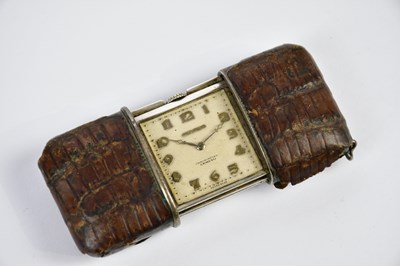 Lot 2354 - MOVADO; a crocodile skin cased purse watch,...