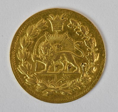 Lot 1611 - A small Persian/Iranian gold coin with a lion...