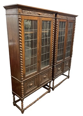 Lot 27 - A pair of 1920s carved oak display cabinets on...