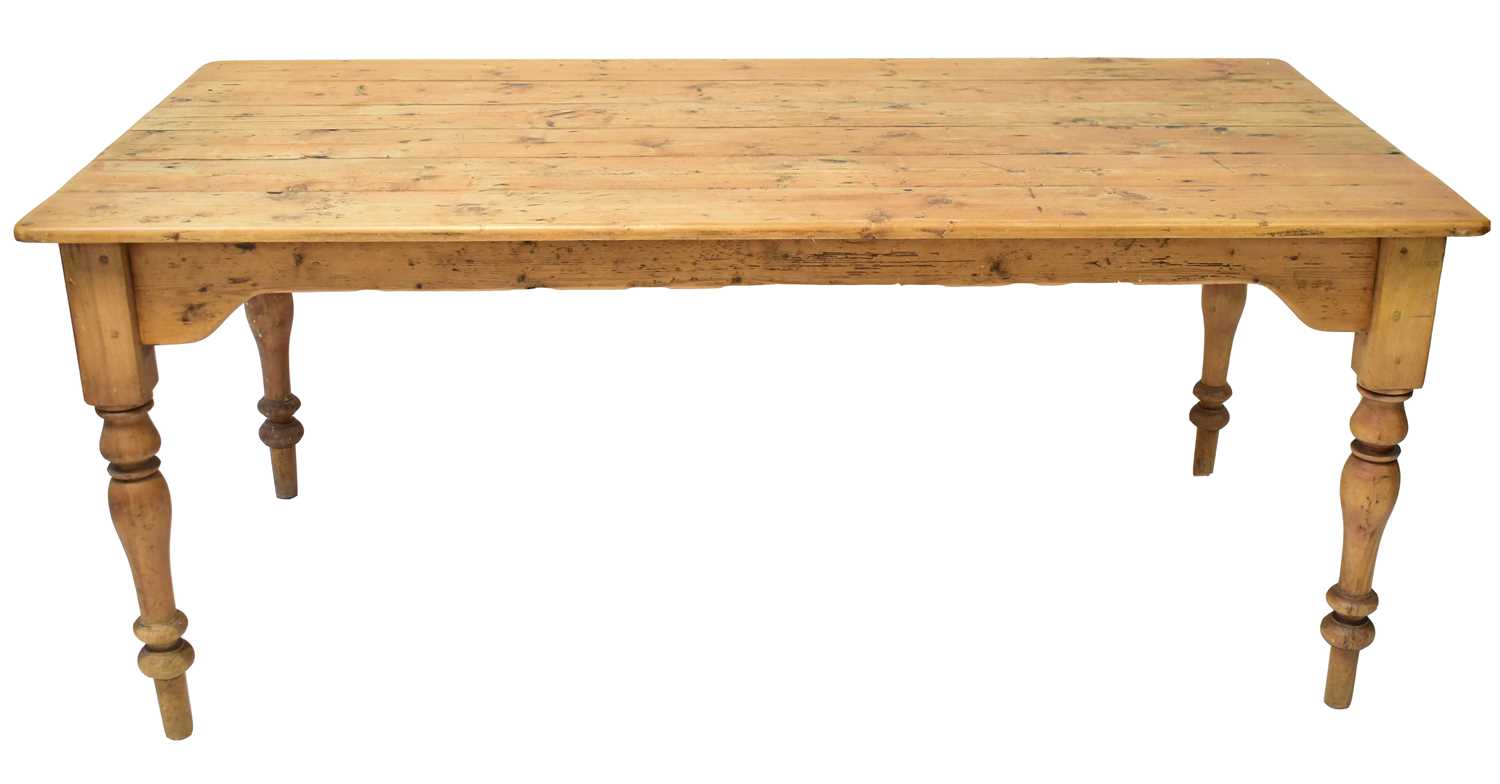 Lot 64 - A large rustic pine farmhouse table of plank...