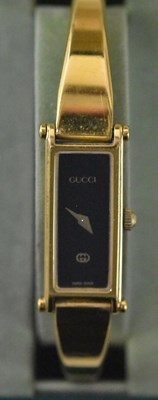 Lot 1449 - GUCCI; a yellow metal lady's wristwatch, the...