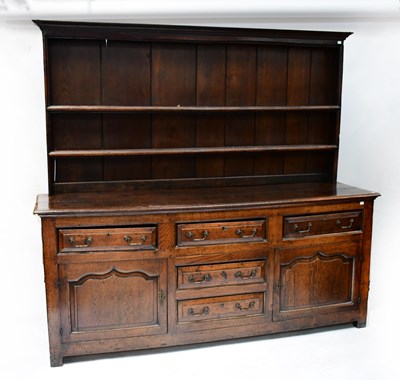 Lot 27 - A George III oak dresser with enclosed plate...
