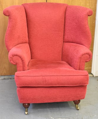 Lot 53 - A good reproduction red upholstered wing...