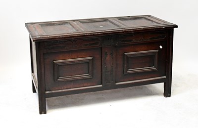 Lot 111 - A Georgian oak coffer with panelled lid above...