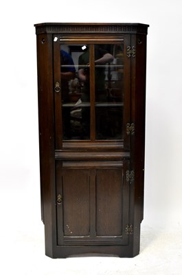 Lot 55 - An Old Charm oak floor standing corner...