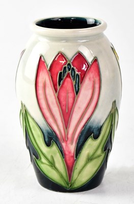 Lot 127 - MOORCROFT; a small baluster vase decorated...