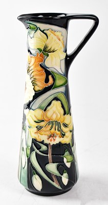 Lot 167 - MOORCROFT; a tapered jug decorated with...