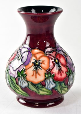 Lot 130 - MOORCROFT; a vase decorated with pansies,...