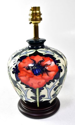 Lot 118 - MOORCROFT; a lamp decorated with poppies on a...