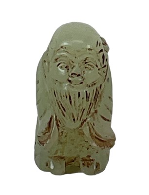 Lot 1140 - A green carved green hardstone figure of Shou...