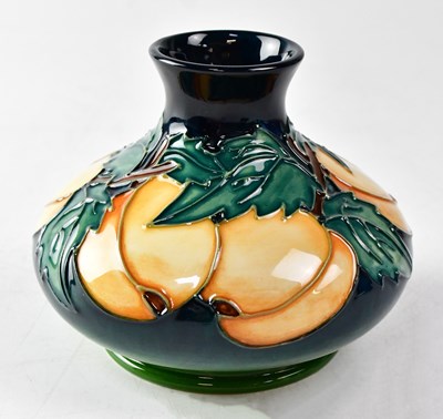 Lot 138 - MOORCROFT; a vase decorated with apricots and...