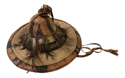 Lot 1230 - An African straw and feather decorated hat,...