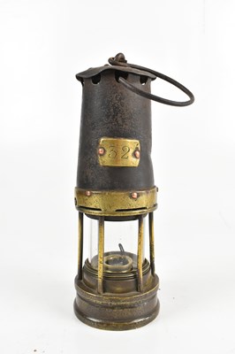 Lot 21 - A 19th century iron and brass miner's lamp,...