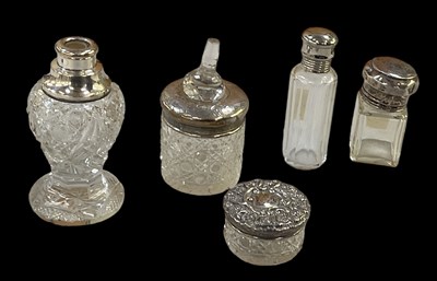 Lot 1304 - A group of four hallmarked silver topped scent...