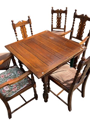 Lot 42 - A 1920s oak draw-leaf dining table on barley...
