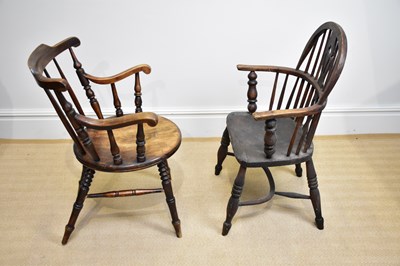Lot 29 - A 19th century elm seated Windsor elbow chair...