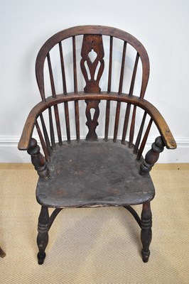 Lot 29 - A 19th century elm seated Windsor elbow chair...