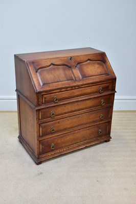 Lot 276 - A reproduction oak bureau, the fall front with...