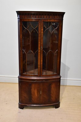 Lot 257 - A reproduction mahogany bowfronted corner...