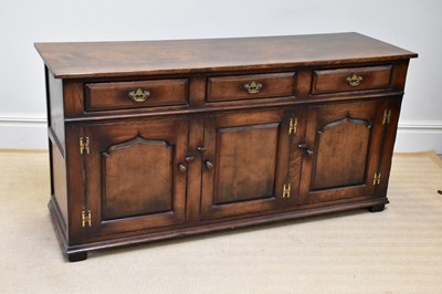 Lot 239 - A reproduction oak dresser base with three...