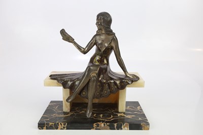 Lot 767 - An Art Deco style spelter figure of seated...