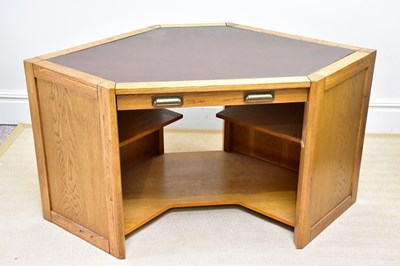 Lot 279 - A modern oak corner desk with brown leather...