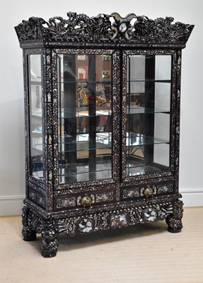 Lot 1159 - A Chinese ebonised carved display cabinet with...