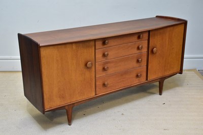 Lot 1007 - A mid century teak sideboard in the manner of...