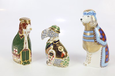 Lot 1364 - ROYAL CROWN DERBY; three dog paperweights,...