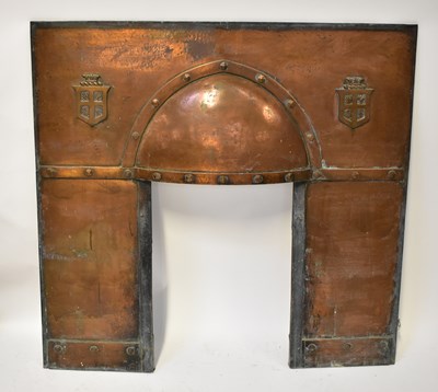 Lot 74 - A hooded copper fire surround with armorial...