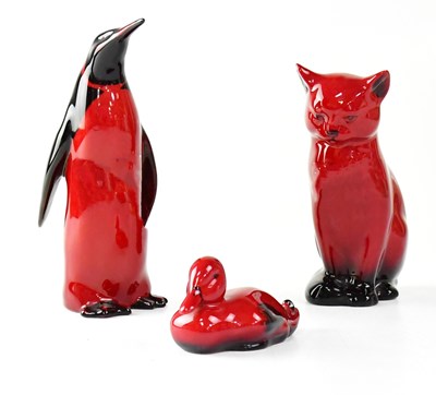 Lot 244 - ROYAL DOULTON; three red flambé glazed figures...