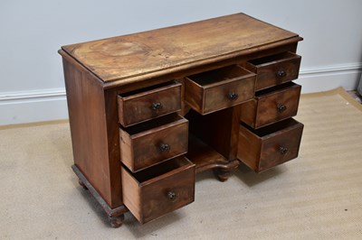 Lot 22 - A small Victorian kneehole seven drawer...