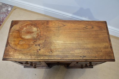 Lot 22 - A small Victorian kneehole seven drawer...
