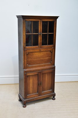 Lot 41 - A 1920s oak bureau cabinet, with a pair of...
